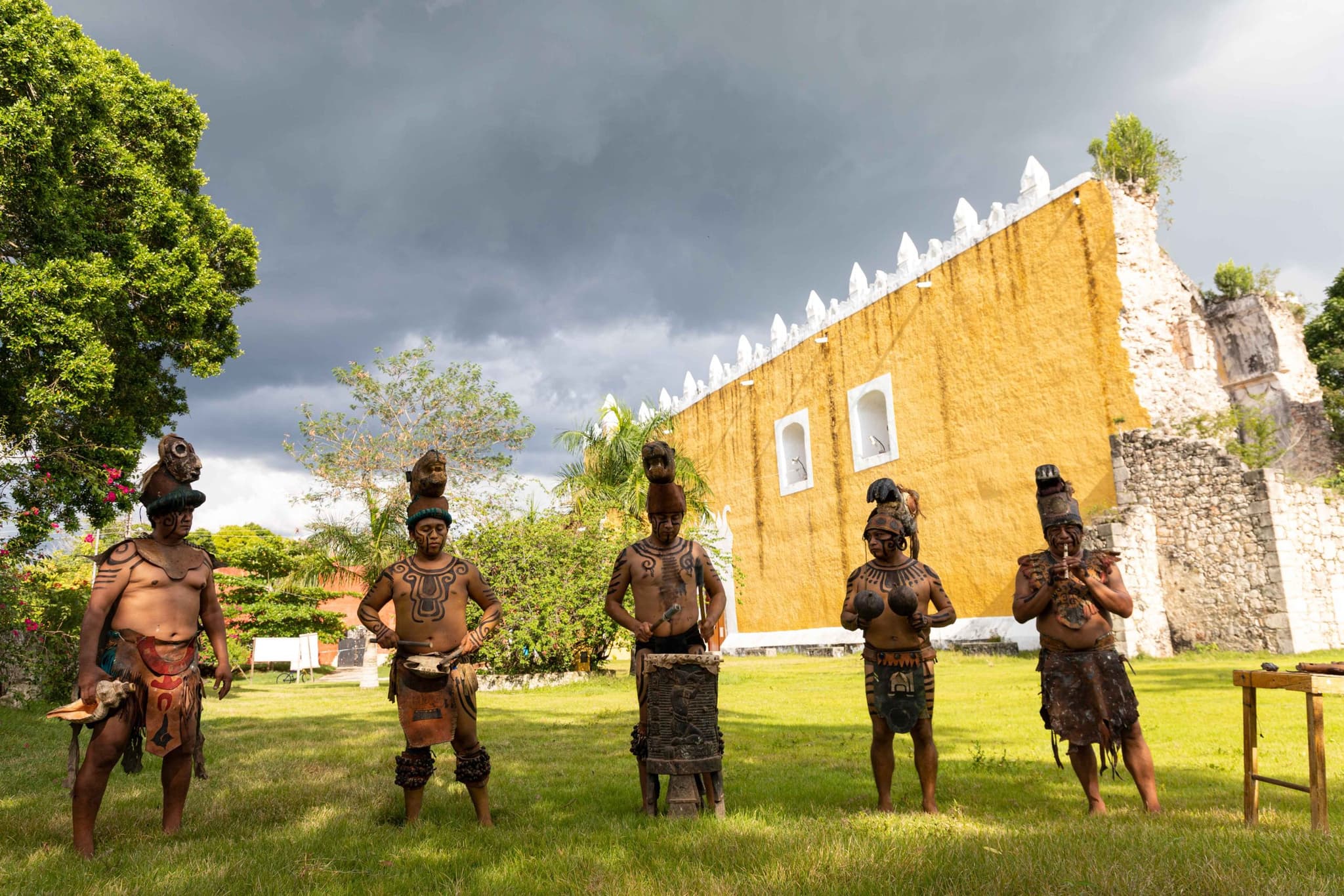 Guardianes mayas frente a un edificio histórico en Maya Ka'an